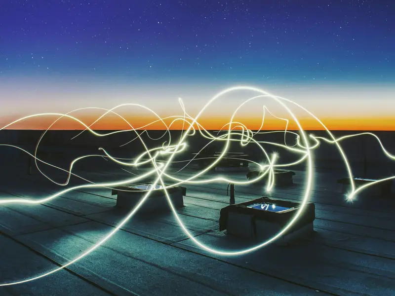 Abstract image taken with a long exposure of light lines over sunset