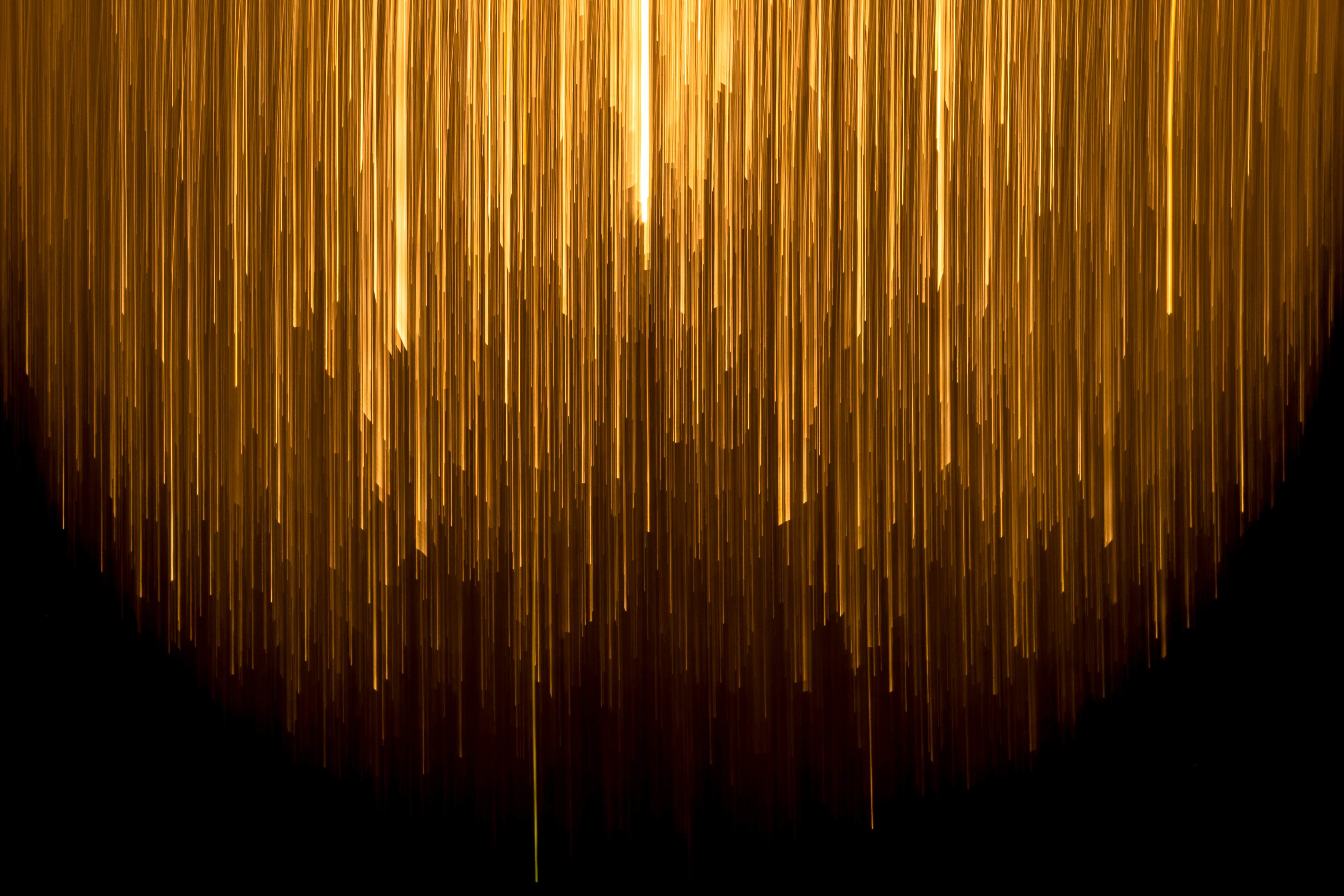 Abstract image showing a shower of warm lights against a dark background