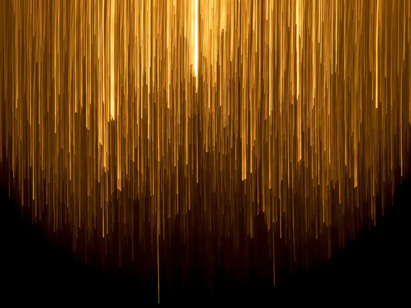 Abstract image showing a shower of warm lights against a dark background