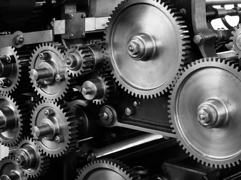 Image of metal cogs and gears as part of a larger machine
