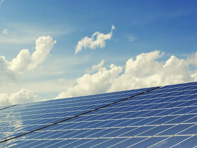 Image showing a panel of photovoltaic cells against a blue sky with clouds