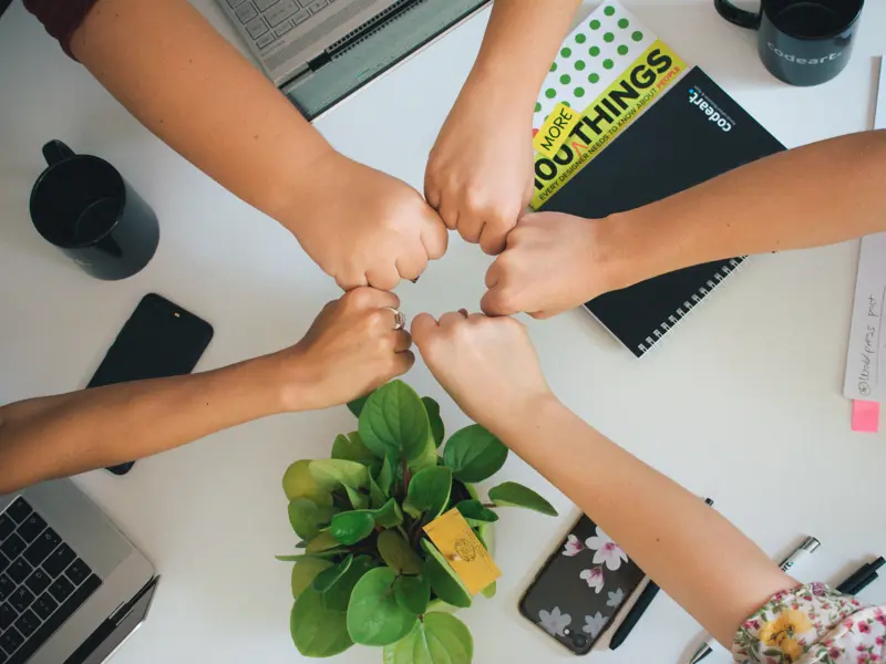 Image of 5 hands all bumping fists together