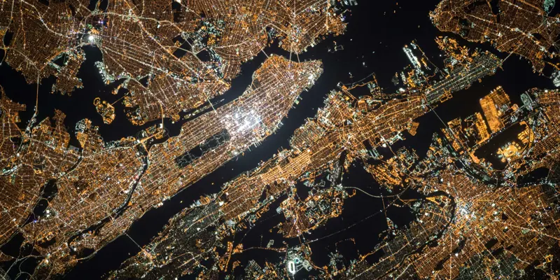 Image showing Manhattan island lit up at at night, taken by a satellite