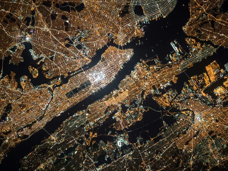 Image showing Manhattan island lit up at at night, taken by a satellite