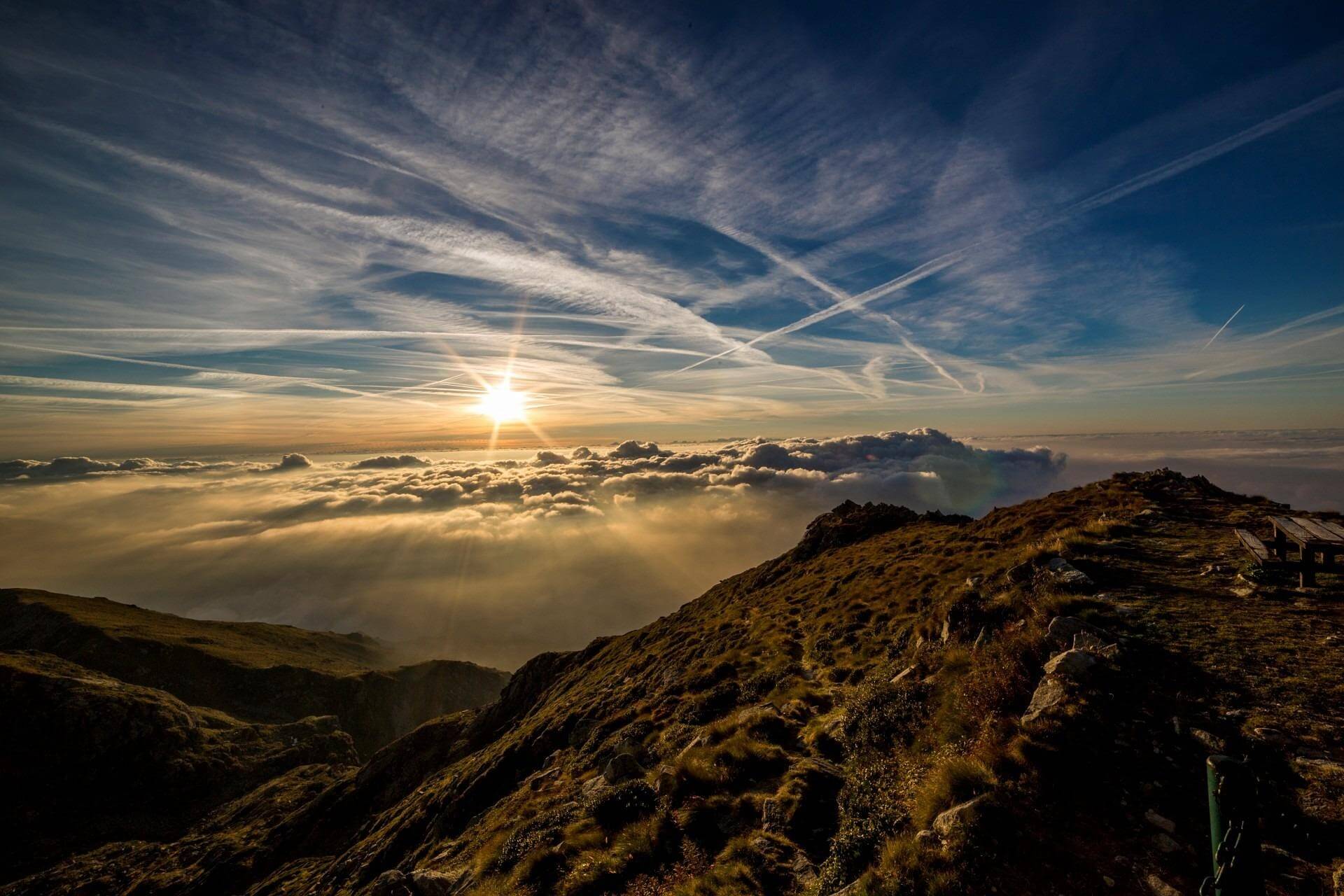 Image showing a range of mountains in the distance with blue sky, hazy clouds and a weak sun shining through